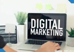 a person typing on a laptop, there is a word on laptop's screen "Digital Marketing".