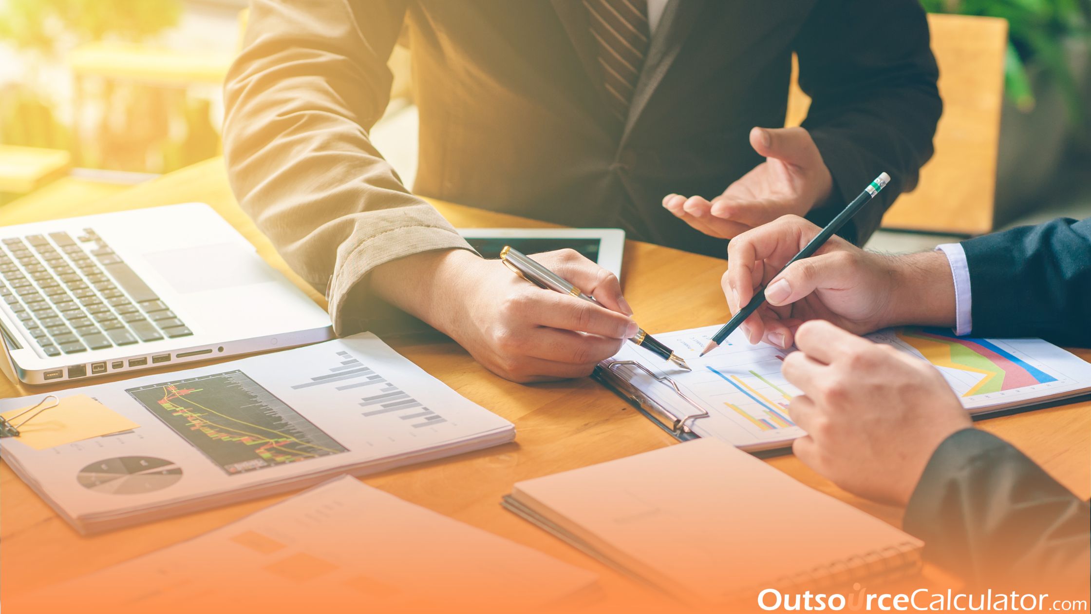 two person talking about business while pointing their pen on paper works