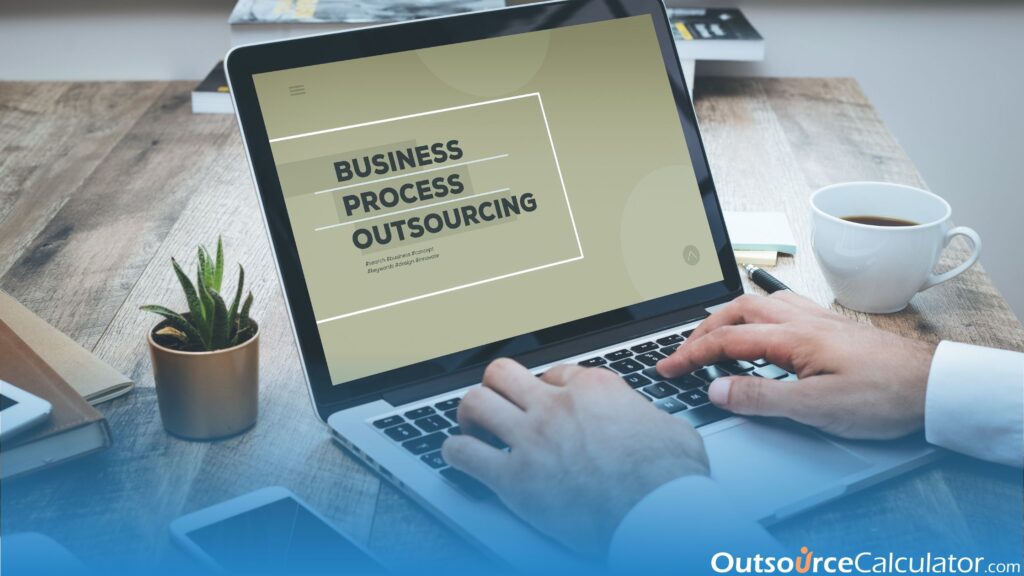 a person typing on a laptop. there is a word "business process outsourcing" on a screen