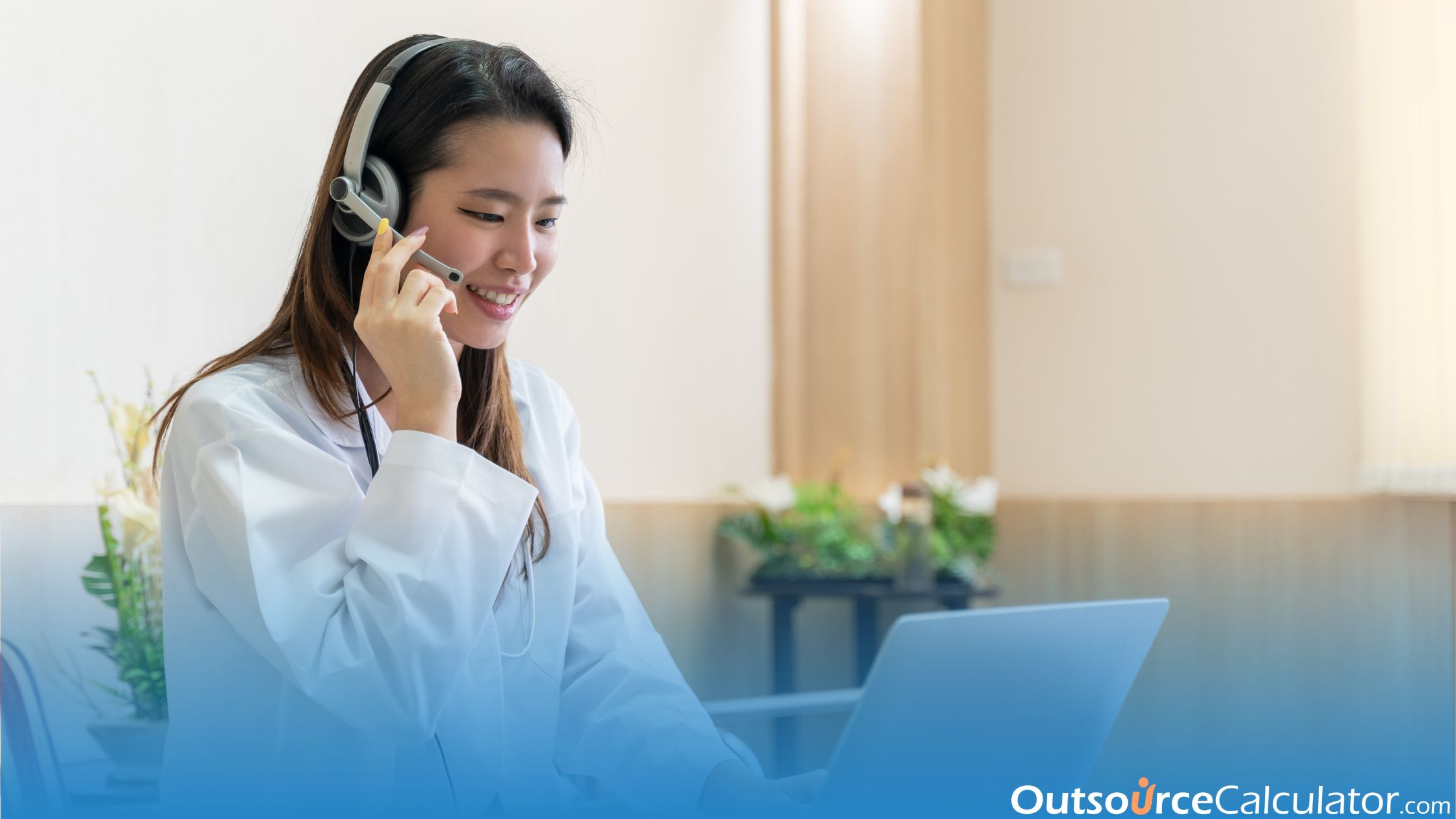 a healthcare staff talking with someone on the laptop, she is also using a headset.